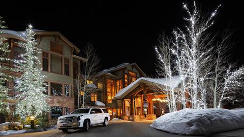 A Deer Valley Cadillac parked outside of Lodges at Deer Valley at night