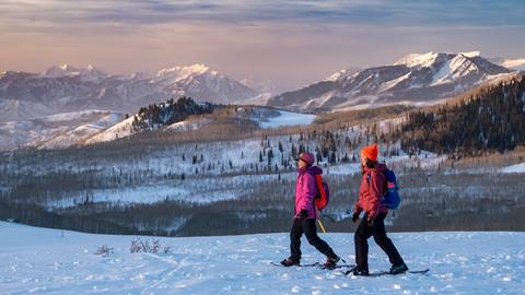 Two guests snowshoeing with All Seasons Adventures.