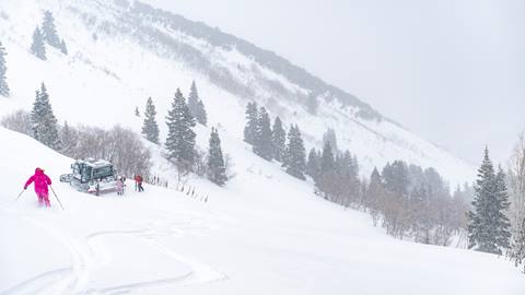 Woman skiing down to snowcat at Deer Valley