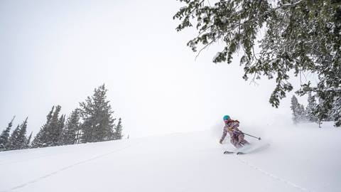 Woman skiing powder at Deer Valley