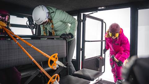 Skiers getting into a snowcat at Deer Valley