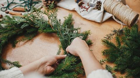 Woman making a winter wreath.