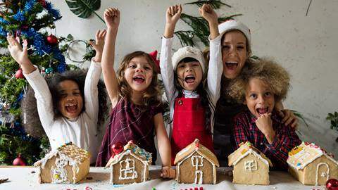 Kids building gingerbread houses.