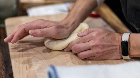 Man kneading dough.