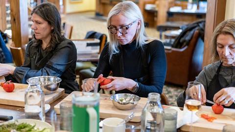 Group of women cutting vegetables in a Deer Valley Creative Academy cooking class.