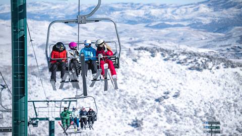 Jillian Vogtli on chairlift with a group of women.