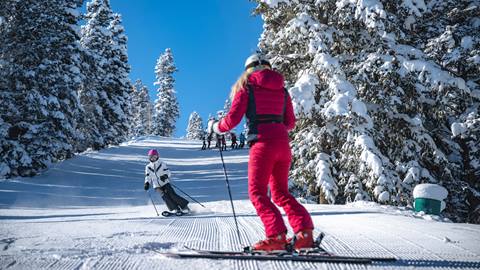 Jillian Vogtli watching a woman ski at Deer Valley.