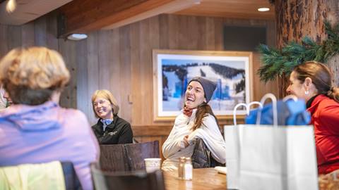 Group of women laughing in Snow Park Lodge at Deer Valley.