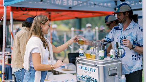 Bartender serves beer to Deer Valley Mountain Beer Festival attendee.