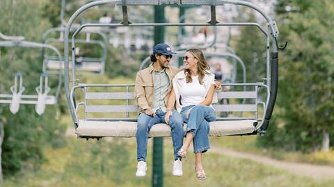 Couple riding chairlift together at Deer Valley during the summer.