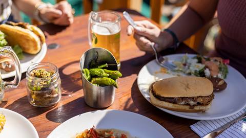 Guests eating lunch outside on the deck at the Deer Valley Mountain Beer Festival.