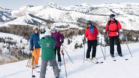 Mountain Host taking photo of guests during tour.