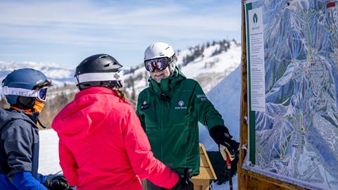 Deer Valley Mountain Host talking with skiers.