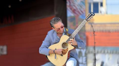 Musician, Nathan Spenser, playing guitar.