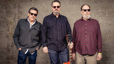 The Mitch Raymond Trio band members wearing sunglasses while looking at the camera.