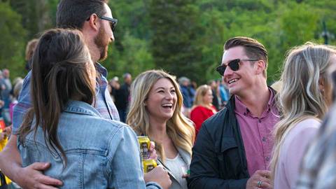 Group of friends socializing at an outdoor event.