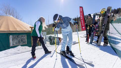 Deer Valley staff helping a guest with demo skis at the Rossignol High Performance Test Center.