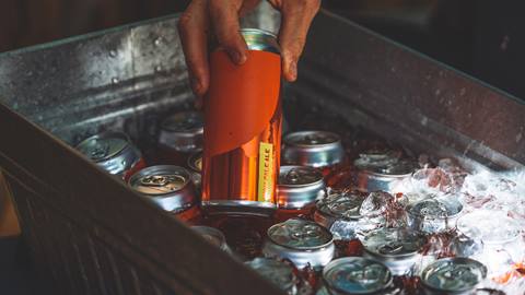Close up of beer can being pulled out of cooler
