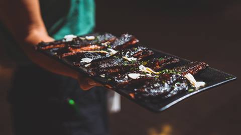 Smoked ribs displayed on serving tray