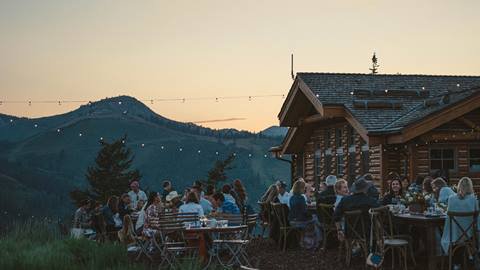 Guests dining outside Cushing's Cabin at summer Taste of Luxury event at Deer Valley.