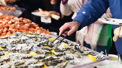 Guests at raw bar with oysters and crab in the VIP Tent at World Cup.