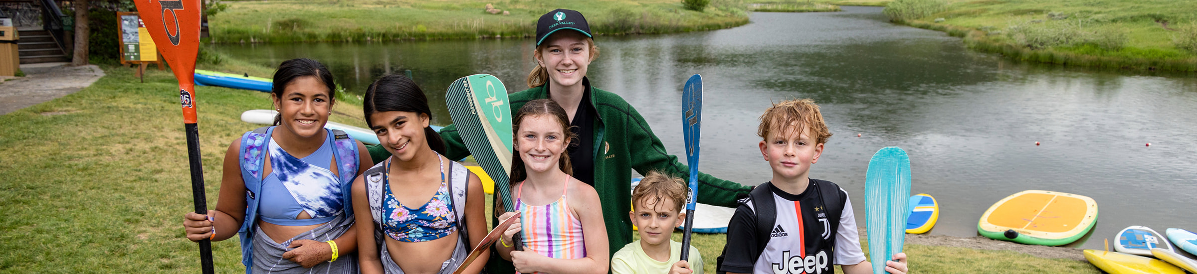 Deer Valley summer camp counselor in group photo with kids at Pebble Beach.