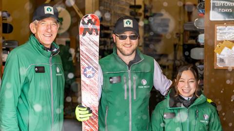 Deer Valley Guest Services staff members assisting guests with storing their skis overnight