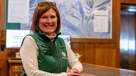 Deer Valley Guest Services staff member standing at the Information Desk.