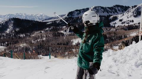 Deer Valley mountain host showing guests where they are skiing at Deer Valley.