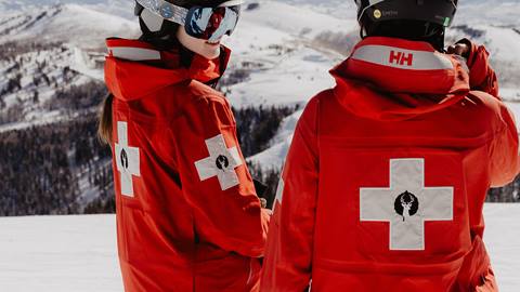 Two Deer Valley Ski Patrol team members looking off into the distance.