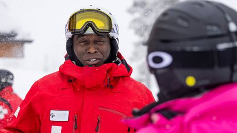 Deer Valley Ski Patrol team member talking with a guest.