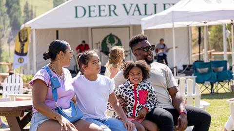 Family listening to live music at Silver Lake Beach in the summer.