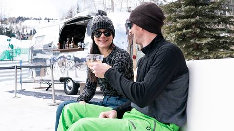 Couple smiling at each other while drinking High West whiskey.