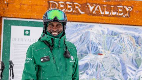 Deer Valley Mountain Host standing at a map.