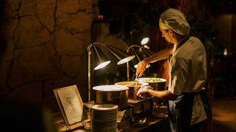 Chef setting up dining service at Cast and Cut Seafood Dining restaurant.