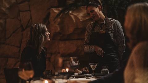 Deer Valley staff member assisting guest at restaurant.