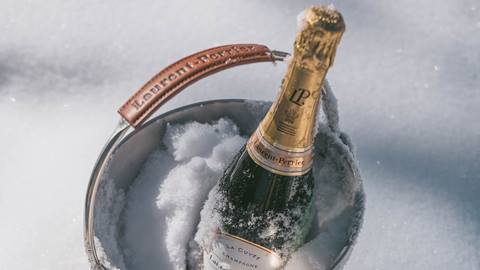 Laurent-Perrier champagne bottle in the snow.