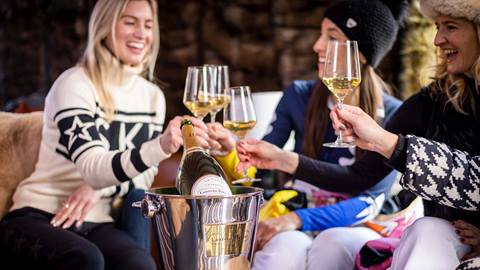 Women cheersing with champagne in Deer Valley's après-ski yurt Chute Eleven