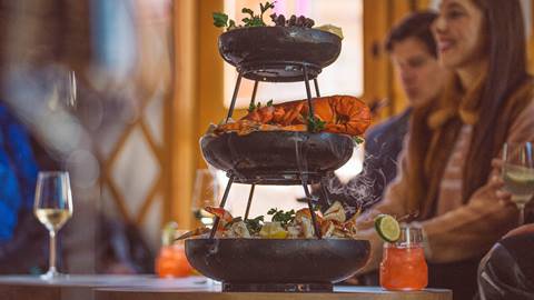 Guests enjoying seafood tower inside Deer Valley's après-ski yurt, Chute Eleven.