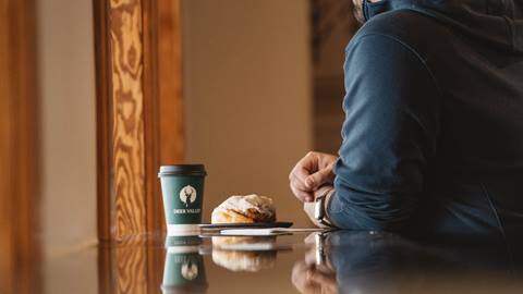 Man having a pastry and coffee at Deer Valley ETC.