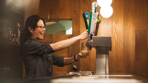 Deer Valley staff pouring beer from tap at Edgar's après-ski bar in Deer Valley.