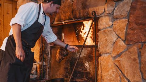 Deer Valley staff with leg of lamb at Fireside Dining.