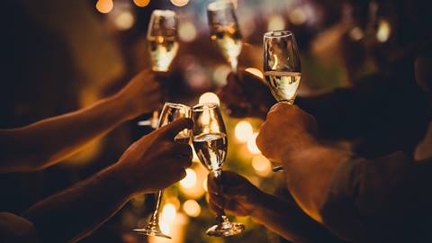 Guests toasting champagne glasses.