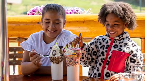 Two girls eating milkshakes at Royal Street Café.