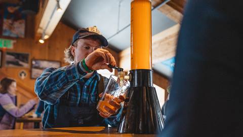 Deer Valley guest pouring beer at The Sticky Wicket.