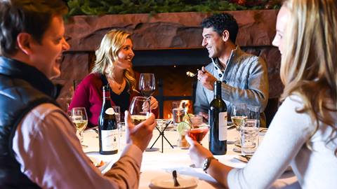 A group of guests sitting down for dinner at the Mariposa restaurant.