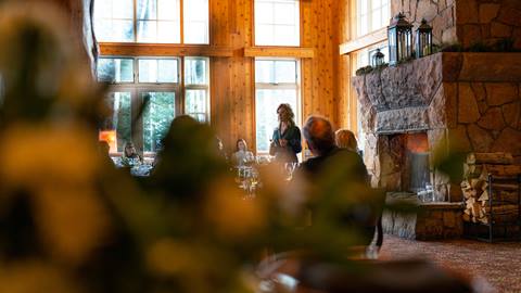 Woman speaking at group event in Empire Canyon Lodge.