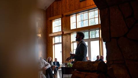 Man giving a speech during an event at Empire Canyon Lodge.