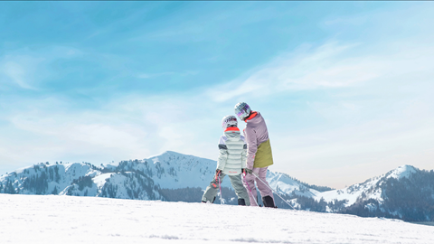 Two people skiing at Deer Valley on a bluebird day.