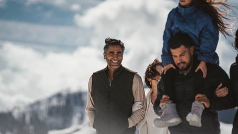 Multi-generational family enjoying winter walk outside at Deer Valley.